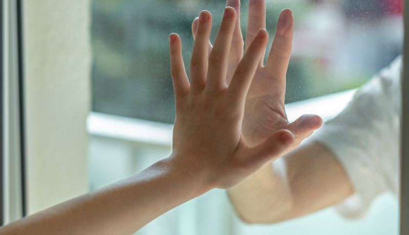 Hands Separated By A Glass Window For Social Distancing During The Picture Id1218753380