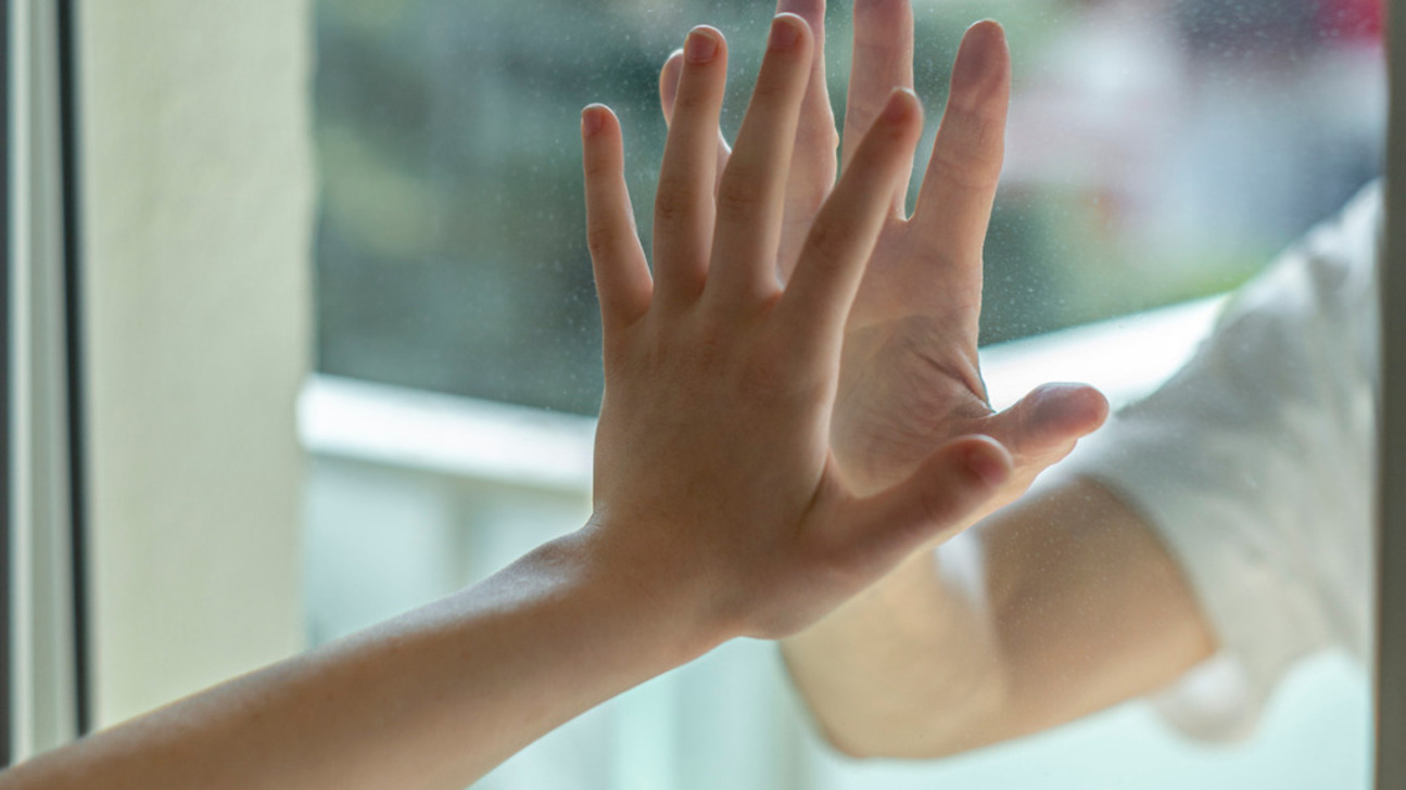Hands Separated By A Glass Window For Social Distancing During The Picture Id1218753380